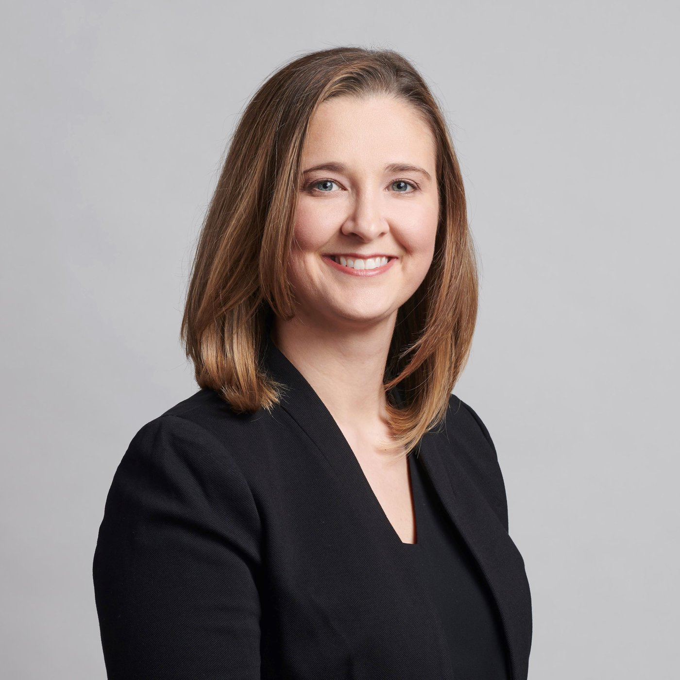 A smiling woman in a black blouse.