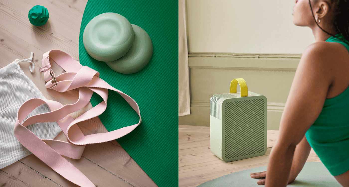 A person doing yoga is surrounded by small circular weights, a yoga strap and mat, and a speaker..
