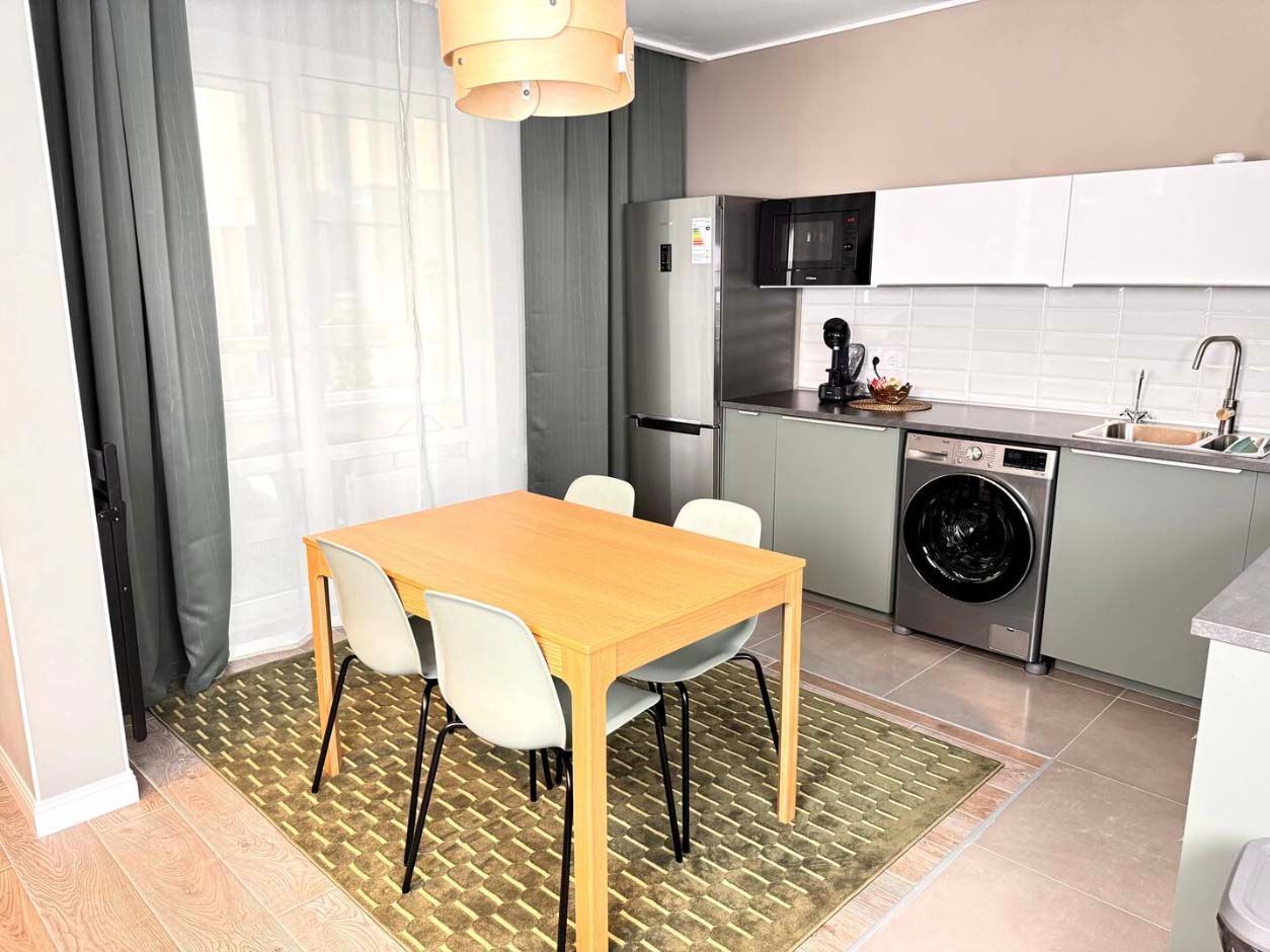 The kitchen and dining area of the Stylish Design Apartments Airbnb in Almaty, Kazakhstan.