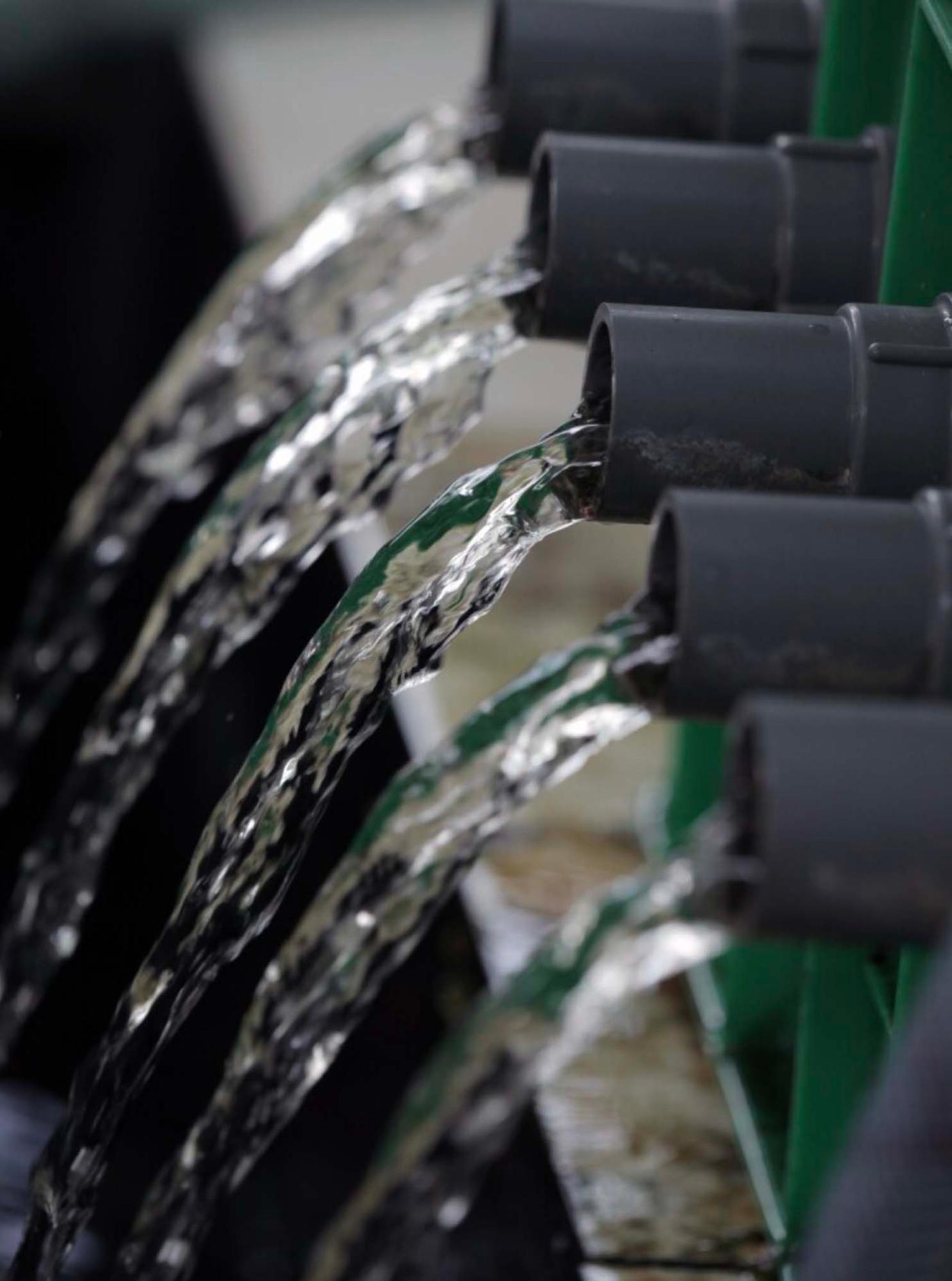 Water runs through a row of spouts.