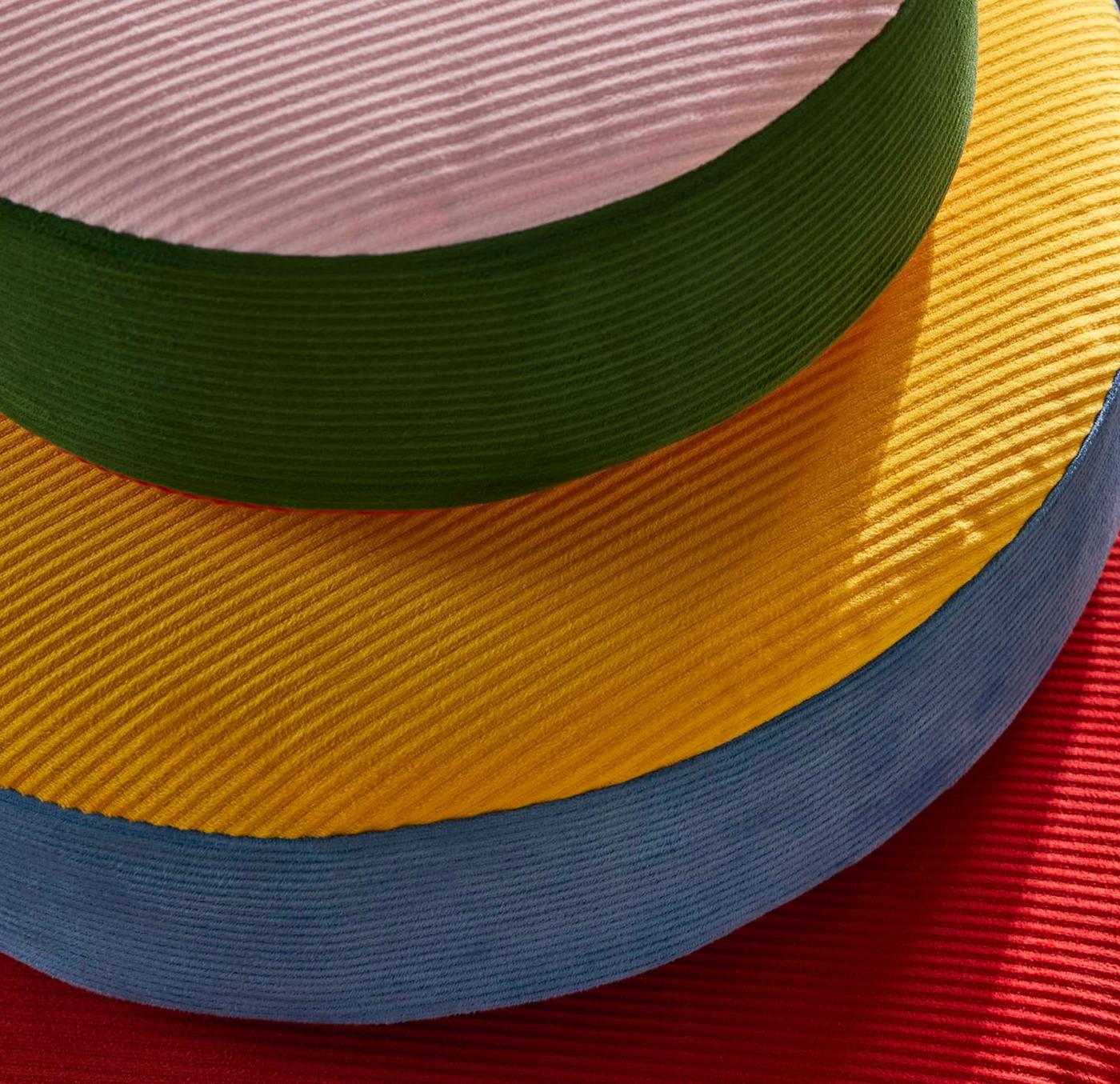 A close-up on three circular corduroy cushions.