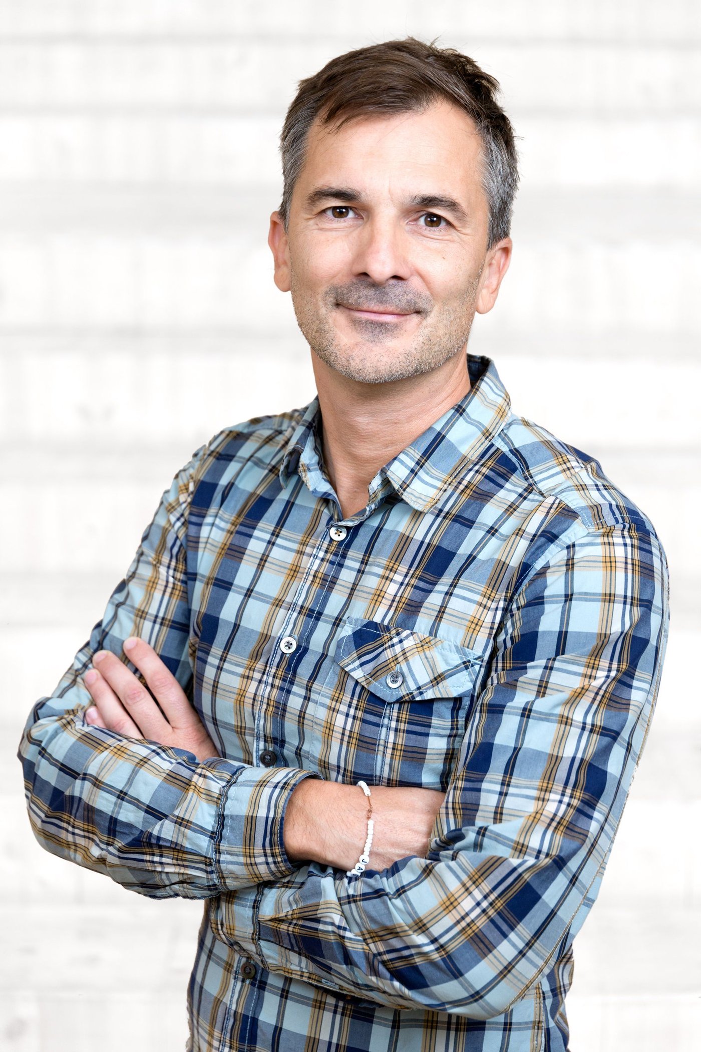 A man wearing a plaid shirt.