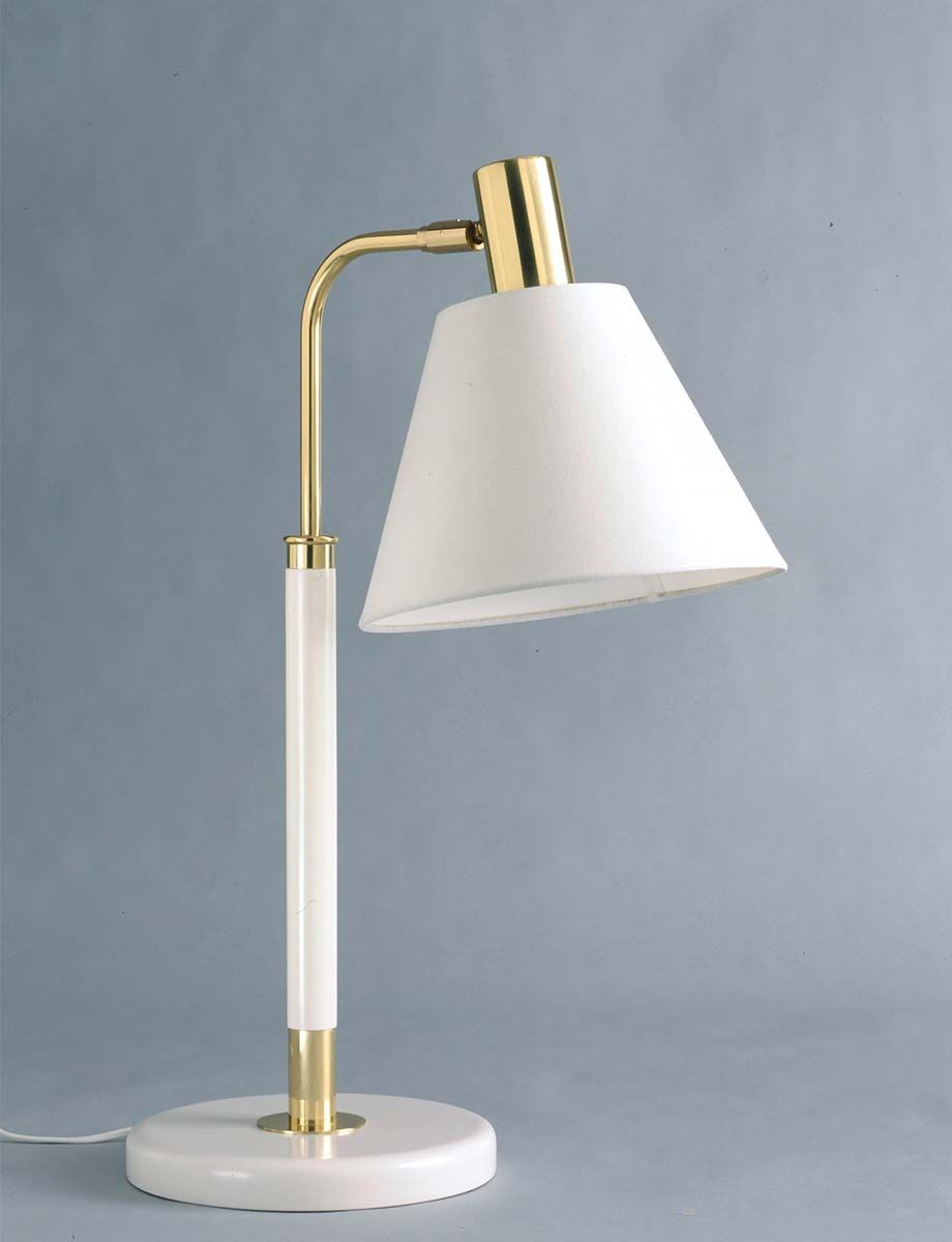 White and brass coloured table lamp against a grey background