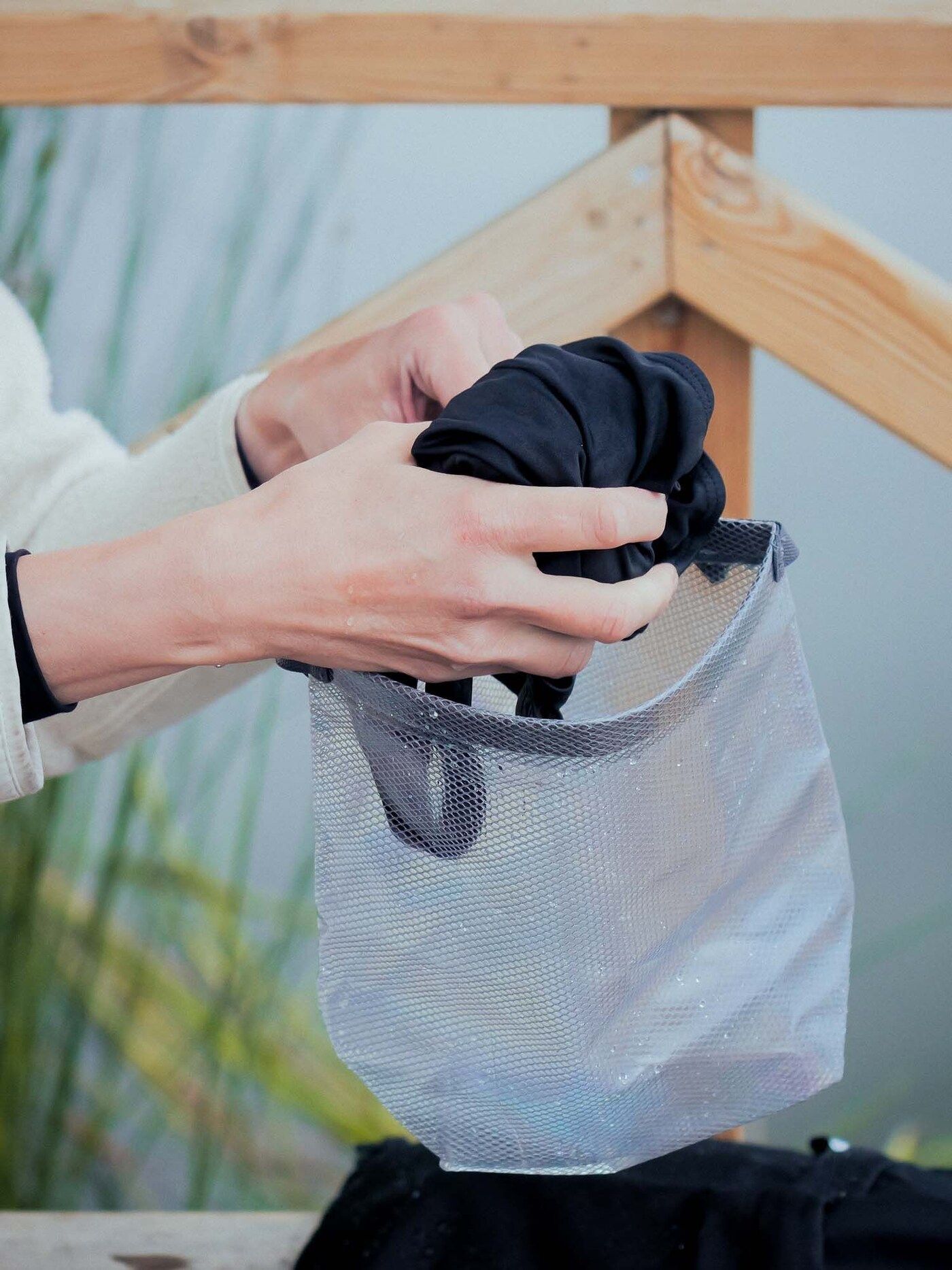 Paulina places her wet swimsuit in a bag.