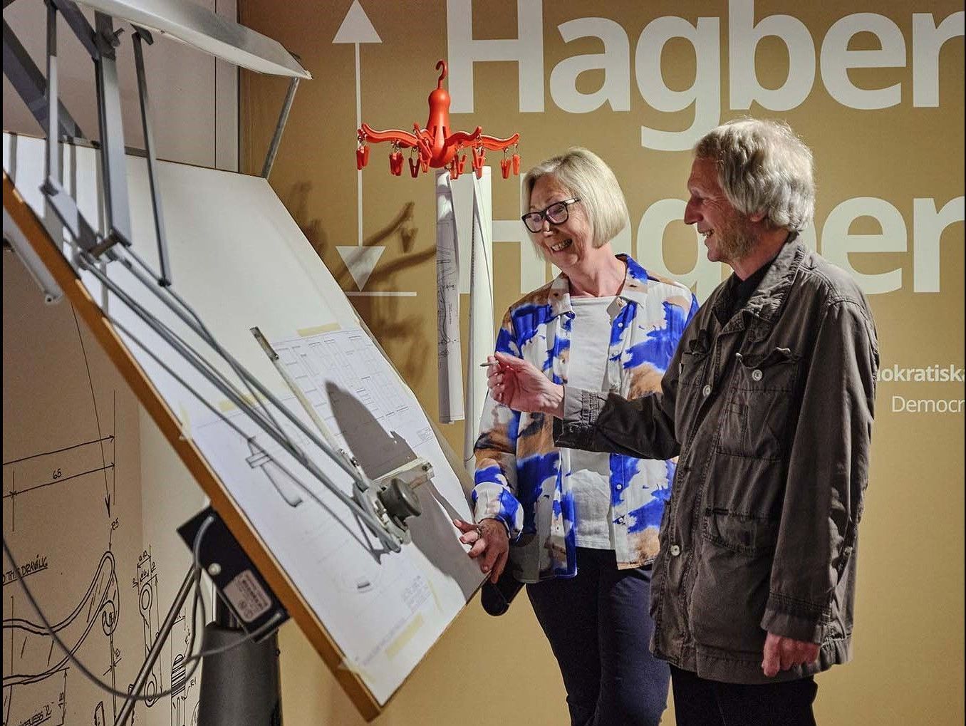 Knut Hagberg and Marianne Hagberg standing at their drawing board at the IKEA Museum.