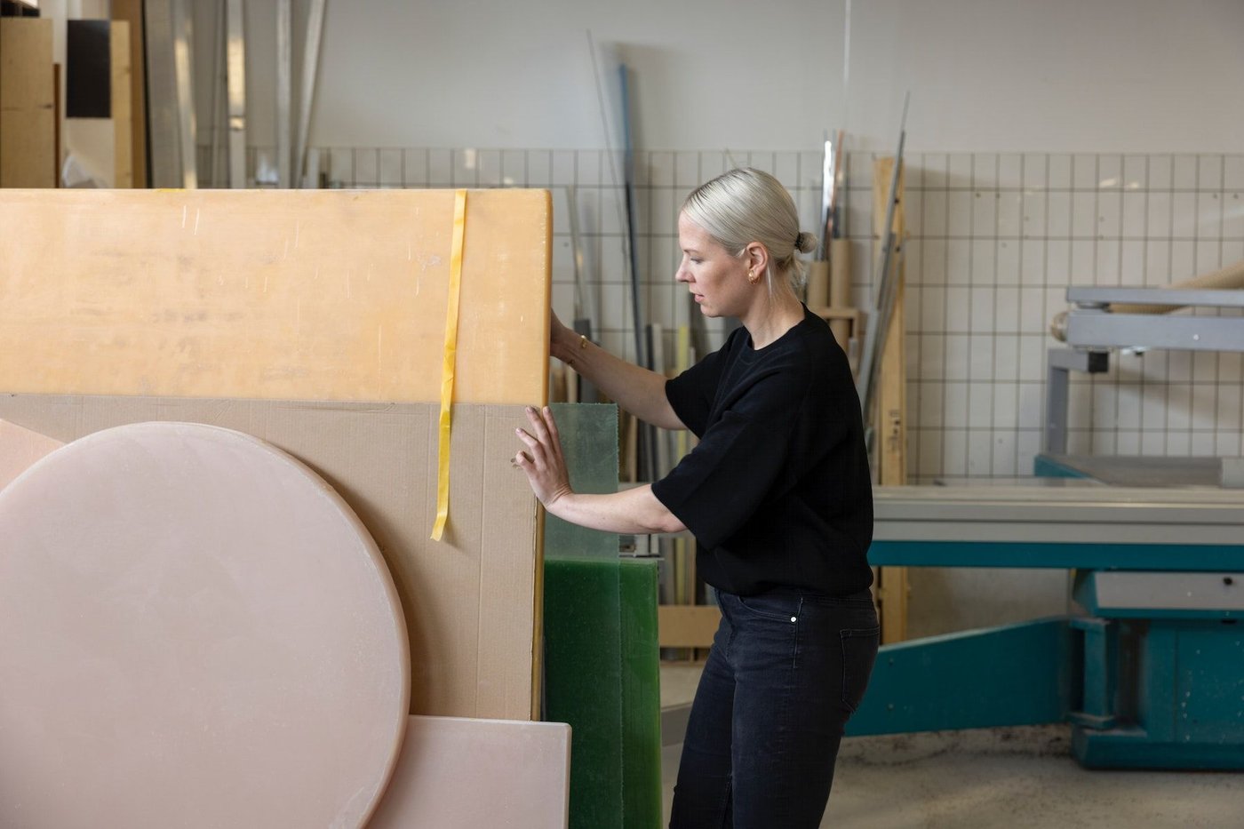 Sabine Marcelis in a workshop, looking through an assortment of sample materials.