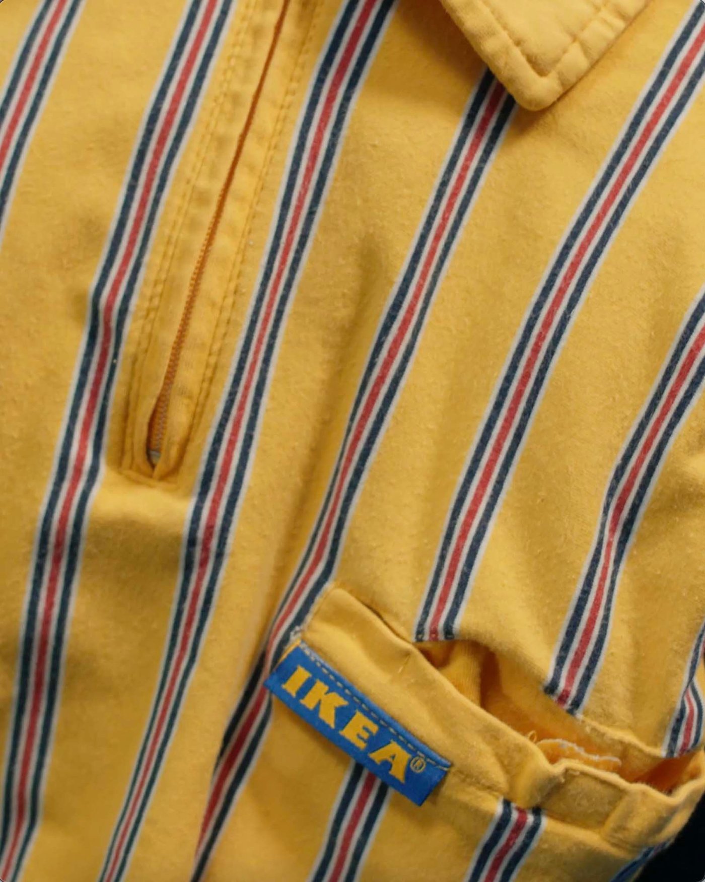 Close up of yellow IKEA co-worker shirt with stripes.