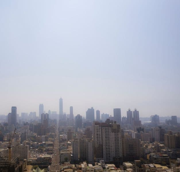 The skyline of a city with a light smog.