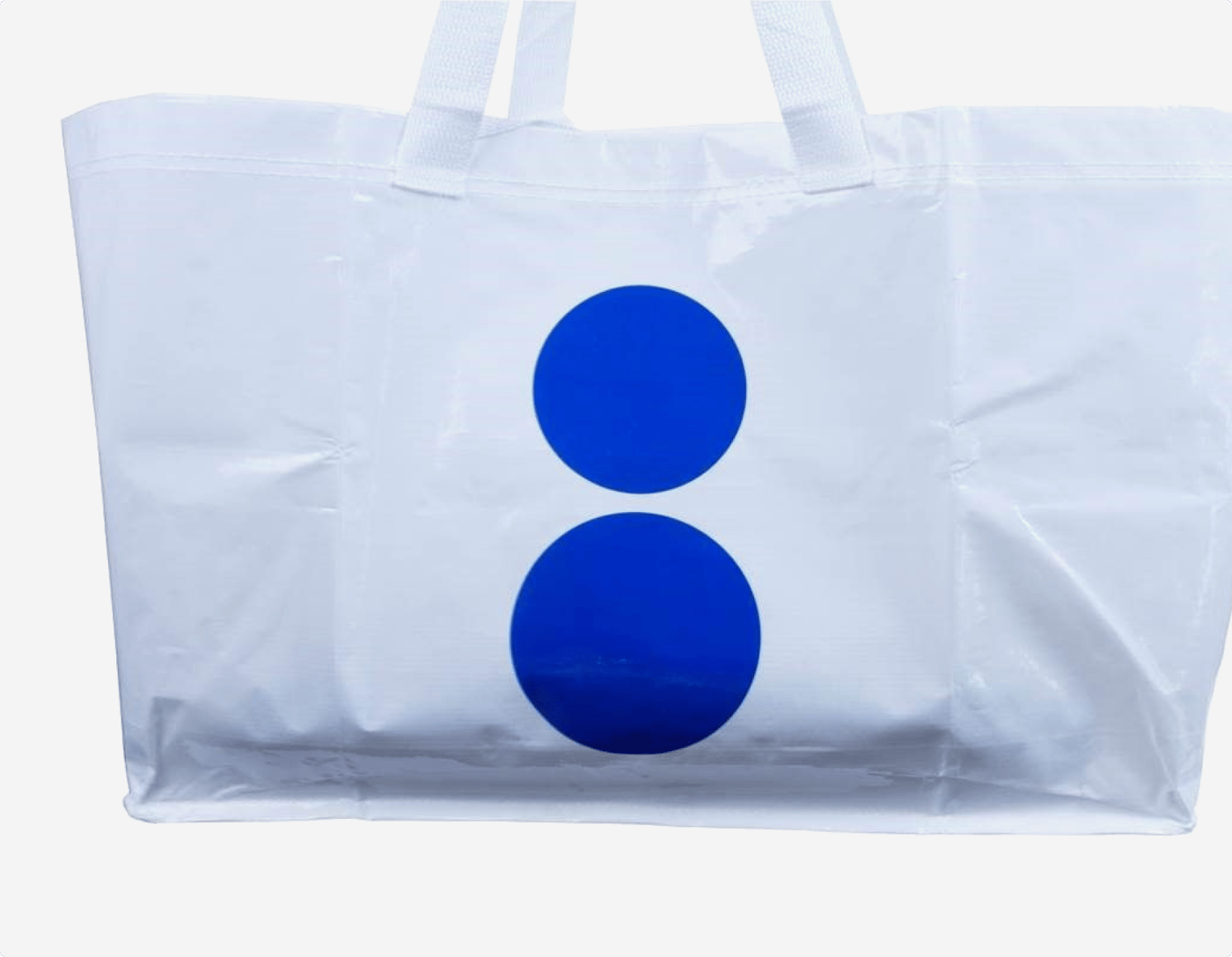 A white bag with two large blue dots, against a white background.