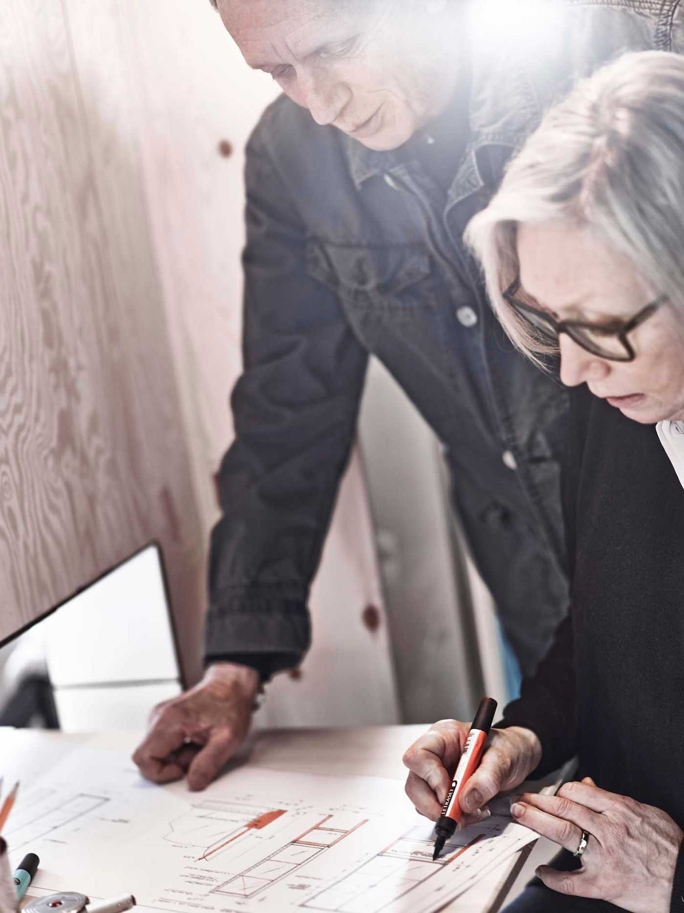 Knut Hagberg and Marianne Hagberg working together on a drawing.
