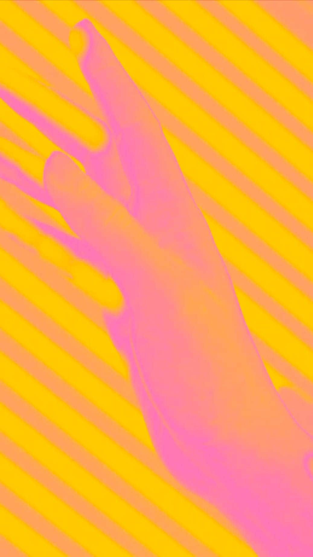 A closeup on a hand against a striped background.