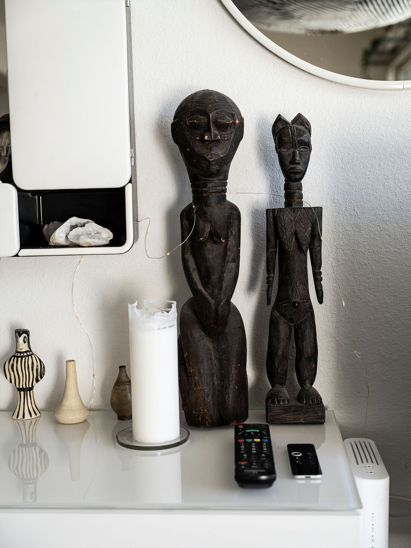 Ornaments stand on a white storage unit.