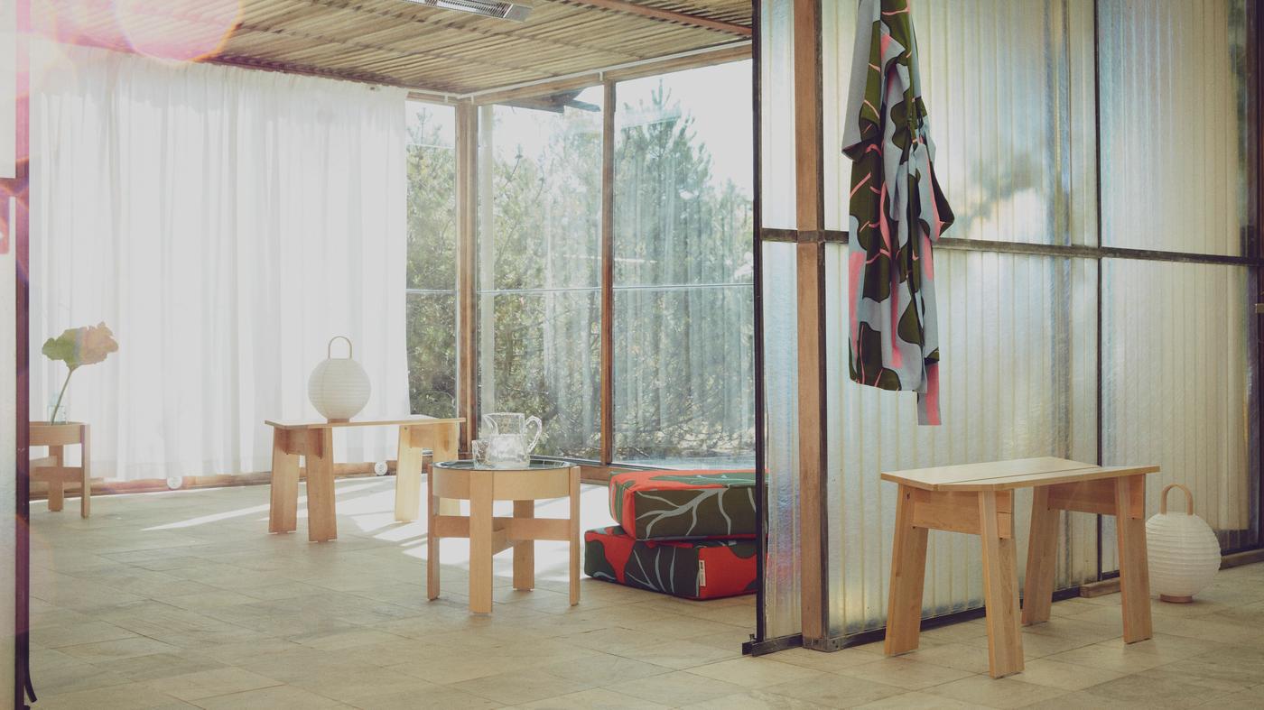 A bathrobe and towels hanging on a wooden wall in a sauna light sauna environment. 
