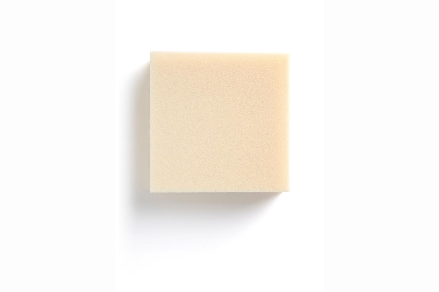 A piece of mattress foam on a white surface.