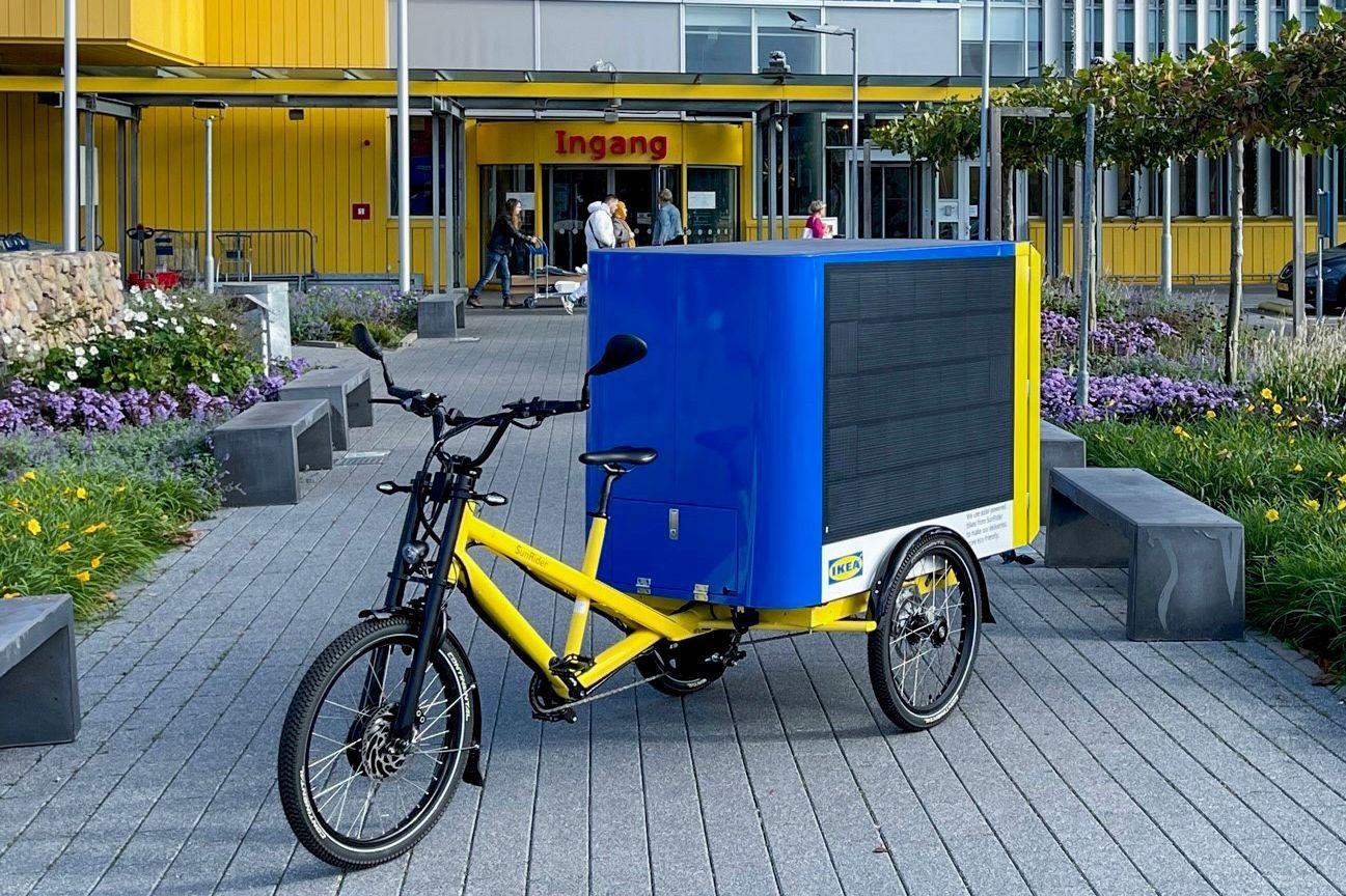 A solar-powered cargo bike parked outside an IKEA store.