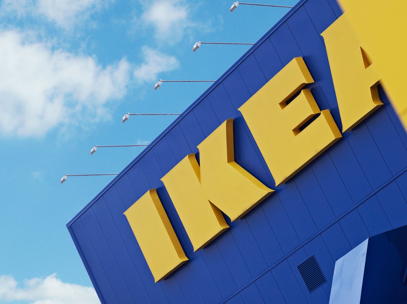 The yellow IKEA letters on the side of blue building.