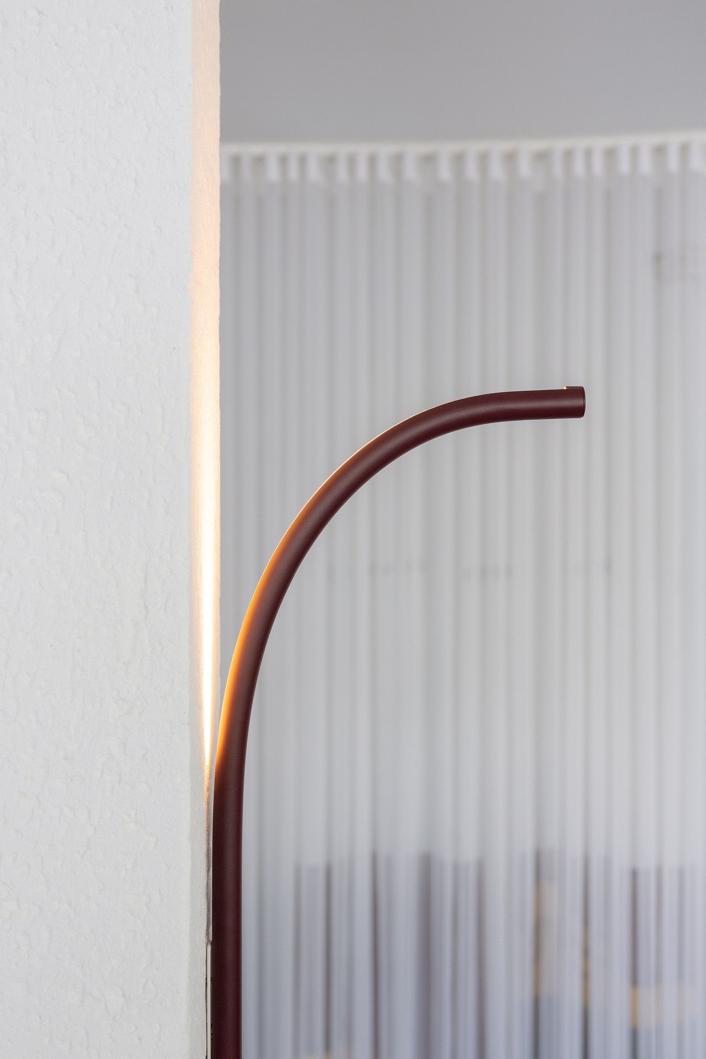 A lamp hanging out from a pillar in a room.