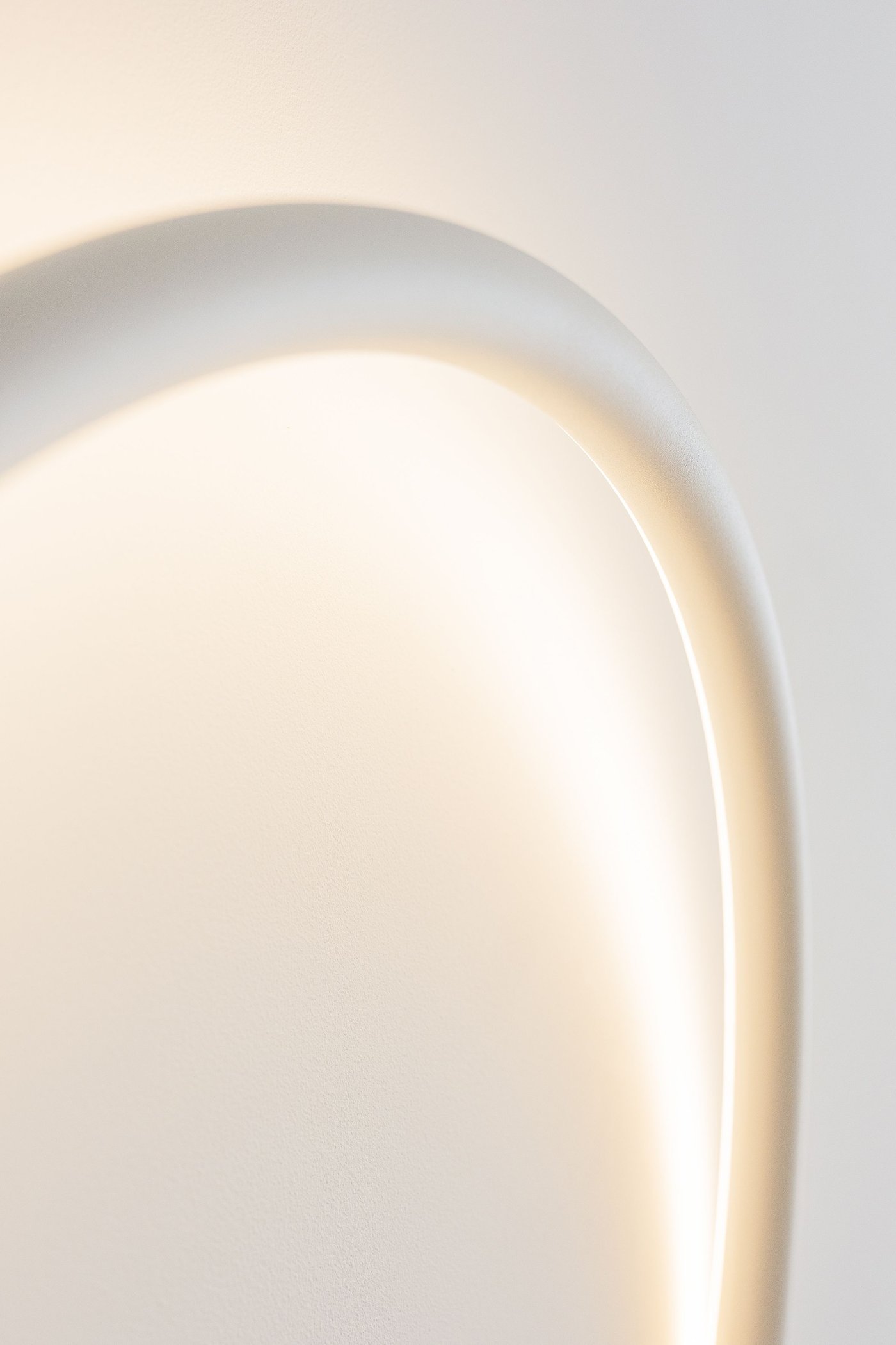A lamp hanging on a white wall.