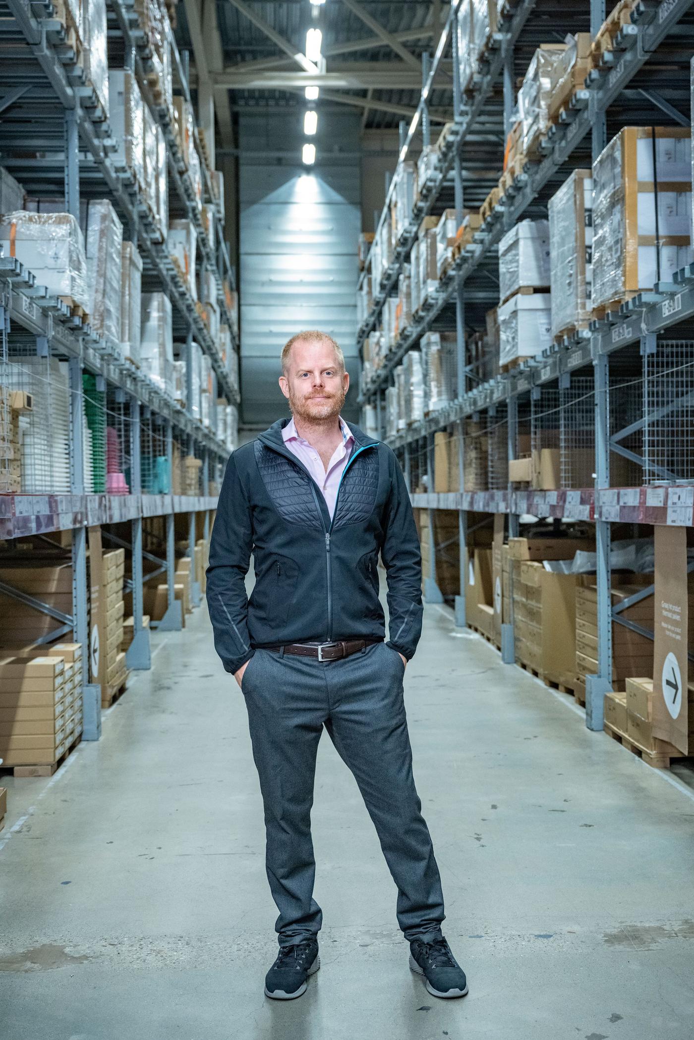 A man standing in an isle at an IKEA store.