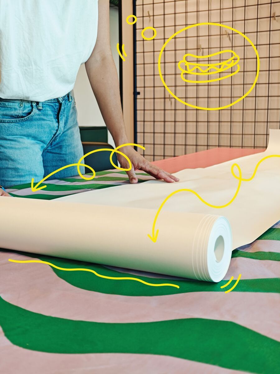 MÅLA paper being unrolled down the middle of a long table.