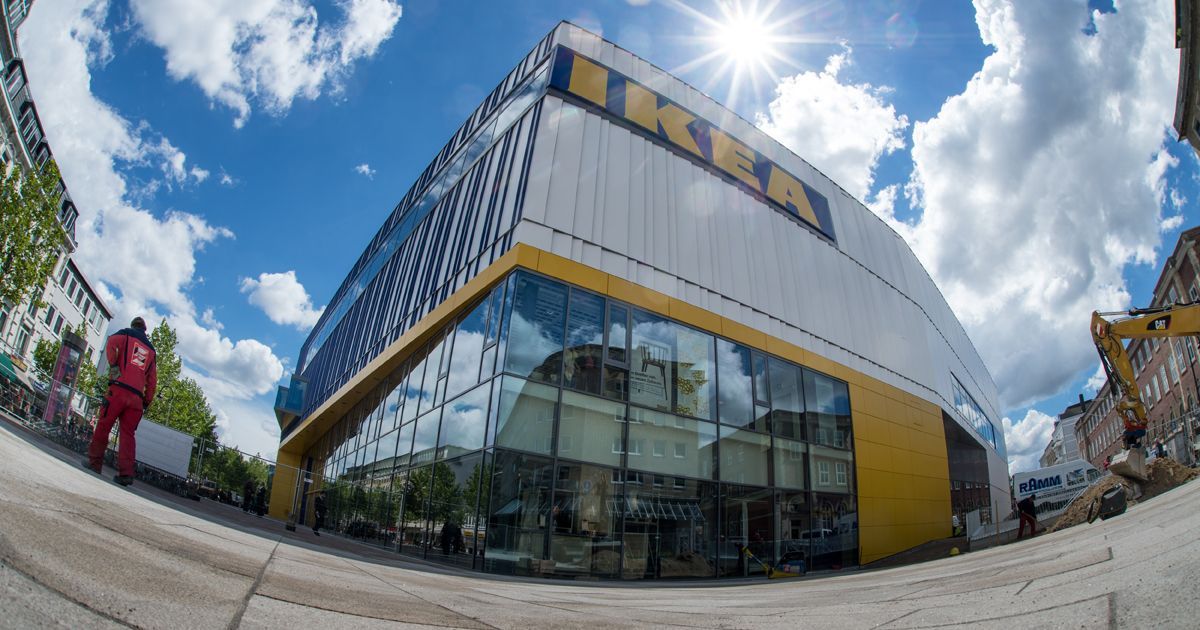The yellow IKEA letters on the side of store against a blue sky.