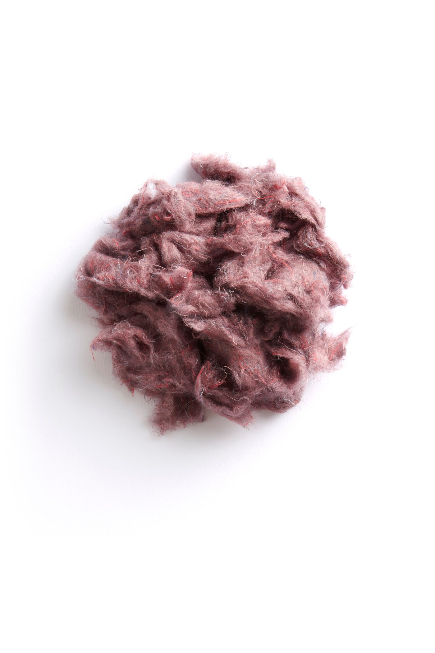 A ball of recycled cotton on a white surface