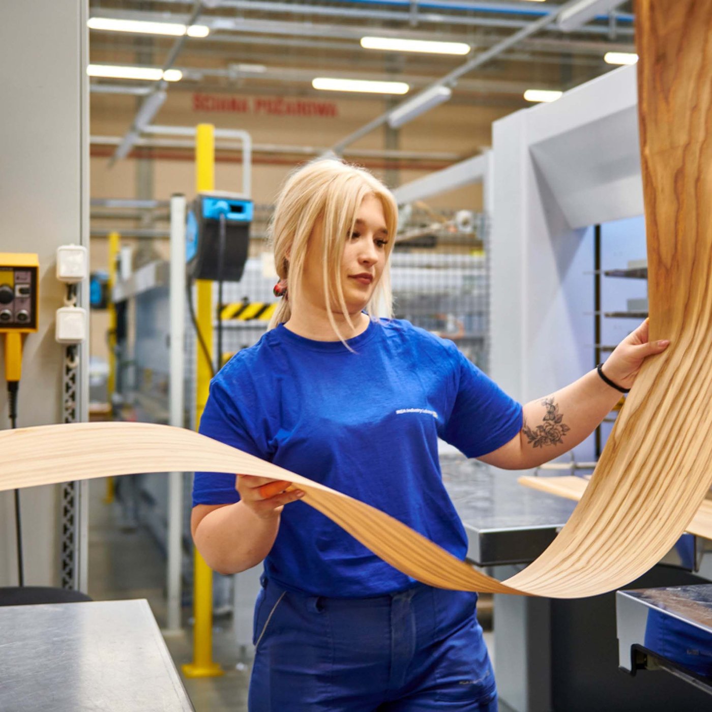 A person inspecting materials in an IKEA Industry factory in Poland.
