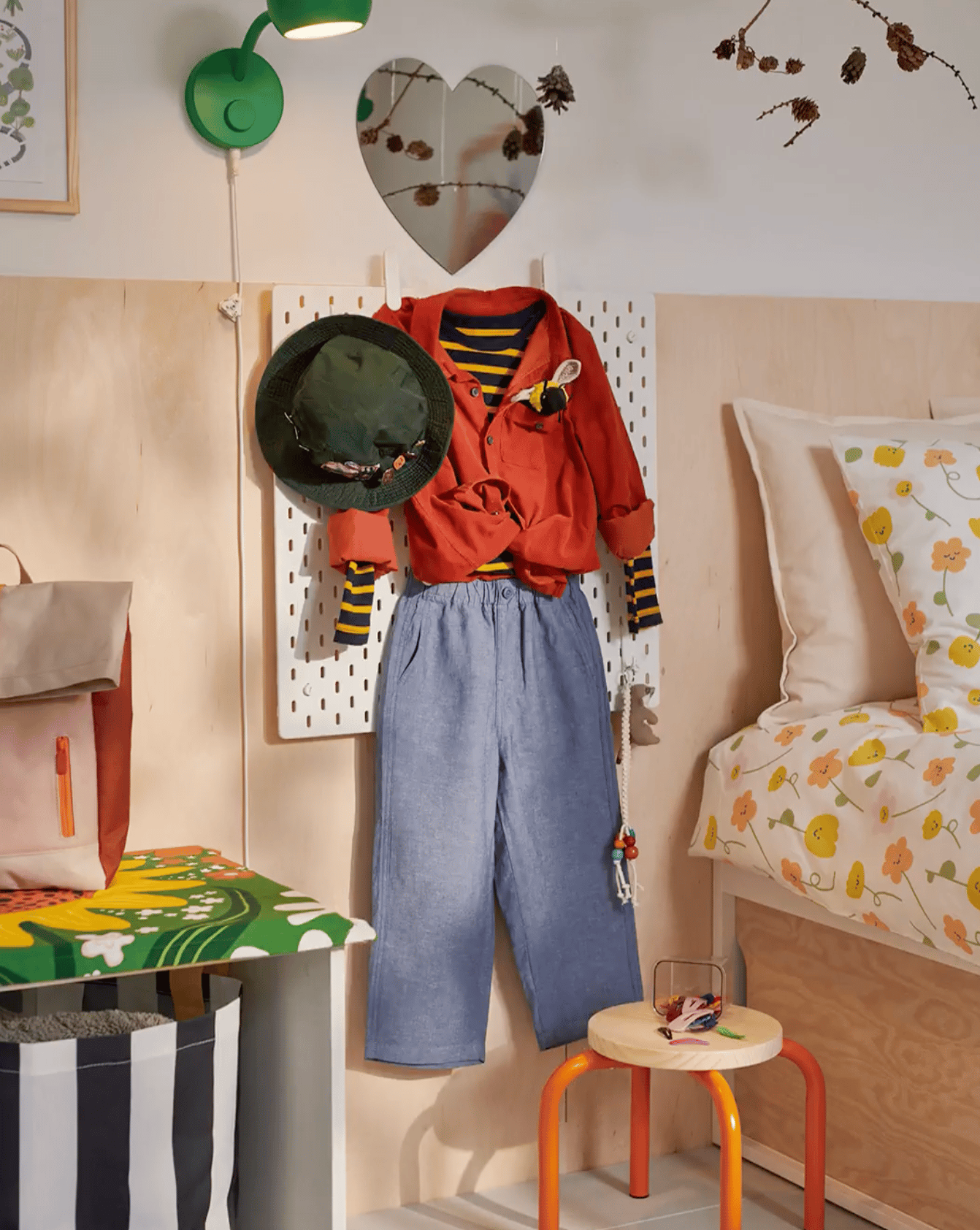 The SKÅDIS pegboard holding together a child's outfit for the next day.