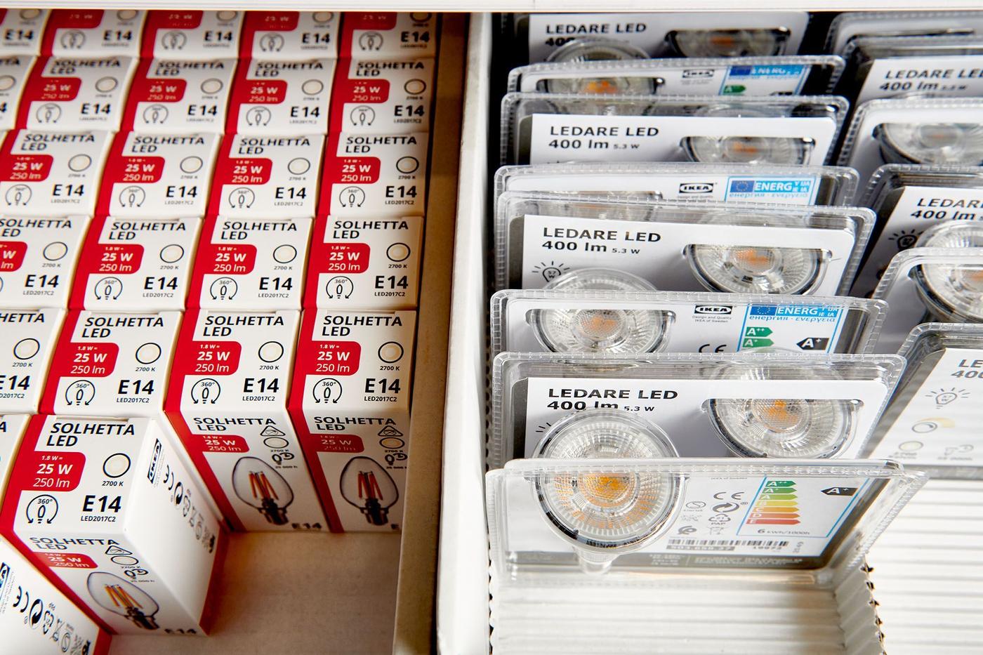 Packaged SOLHETTA & LEDARE light bulbs next to one another on a store shelf.