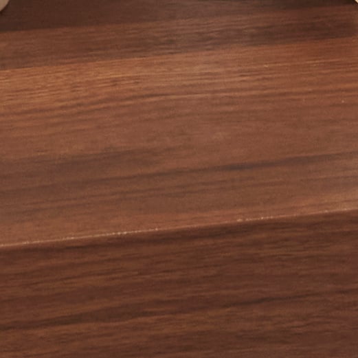 A close-up of a dark wood veneer texture.