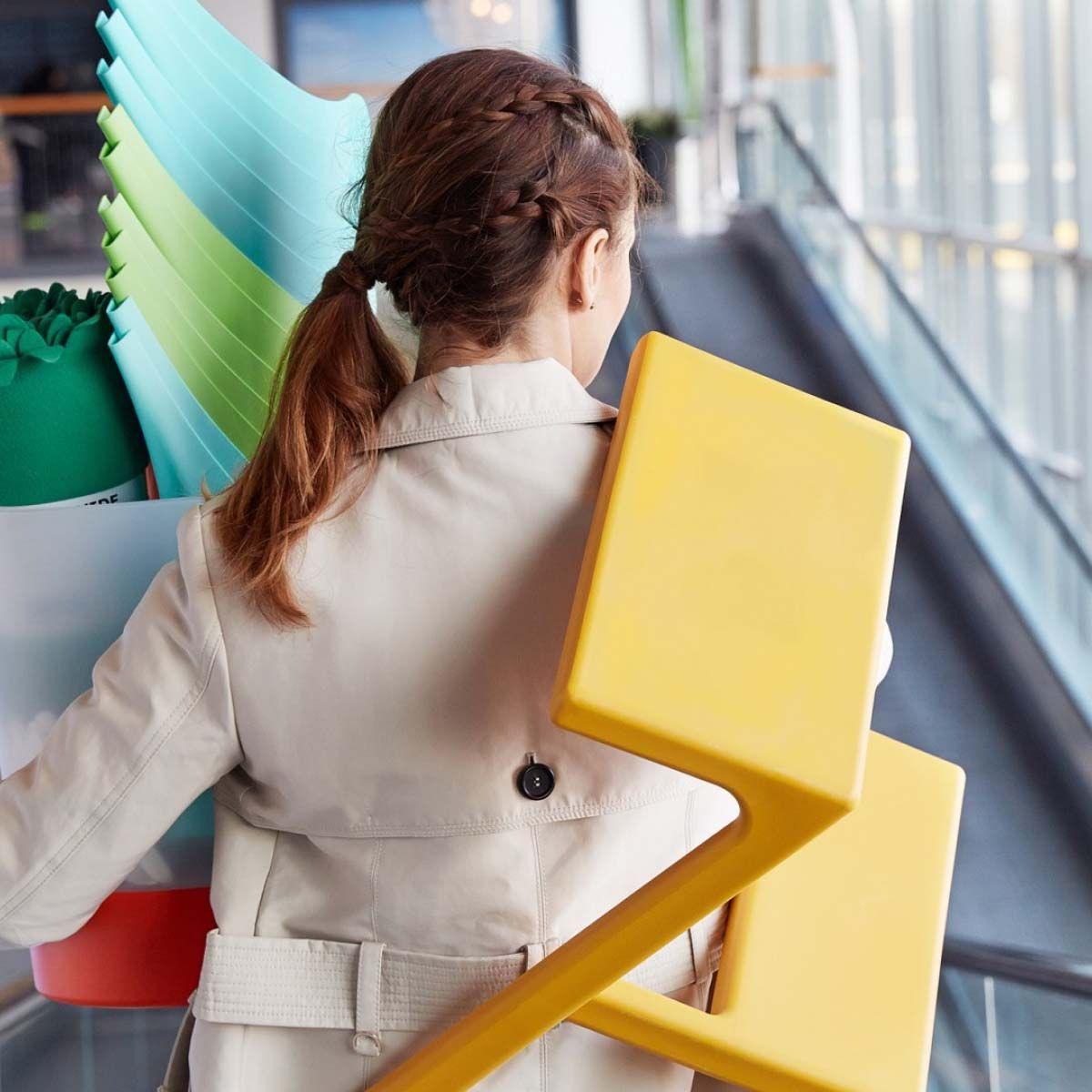 A woman bringing furniture home from the store.