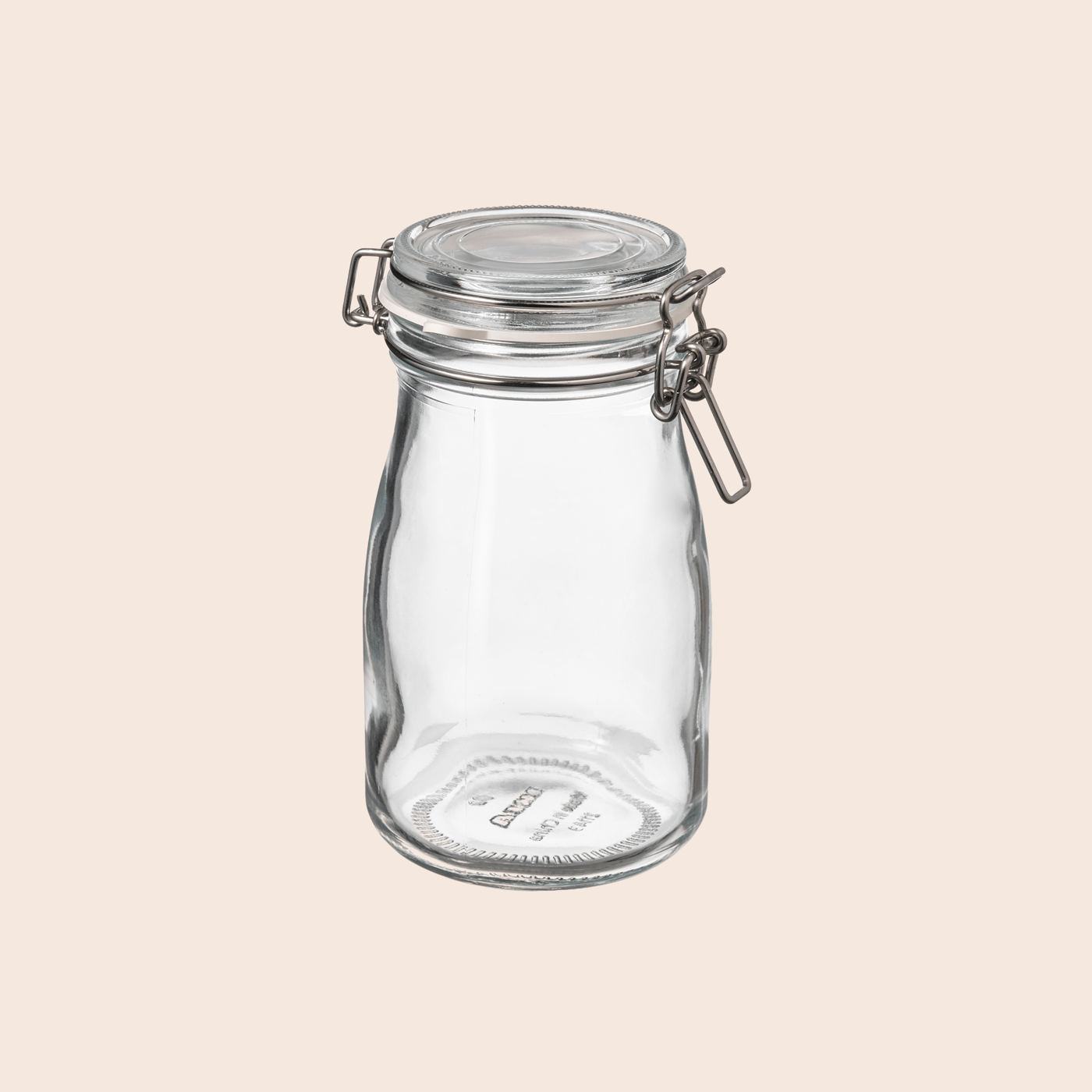 KORKEN glass jar with lid on a light peach coloured background.