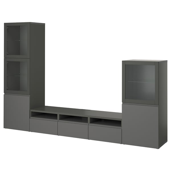 Tamno sivi IKEA BESTÅ TV ormarić s više polica i ladica, kombinirajući pohranu i elegantan dizajn.