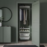 BOAXEL fali tároló: ruhák, polcok, kukák. Zöld fal, tükör, szekrény.