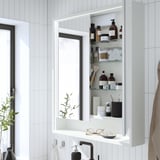 Tükörszekrény lámpákkal: tárolók, piperecikkek, tükrözi a szobát.