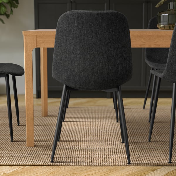 Modern étkező fekete GALLERUD székekkel, minimalista dizájnnal, bézs szőnyeggel.