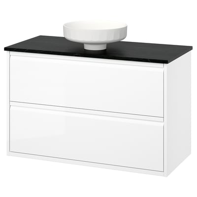 A white ÄNGSJÖN bathroom vanity with a sleek black countertop and round ceramic basin. It has smooth, modern lines and minimalist design.