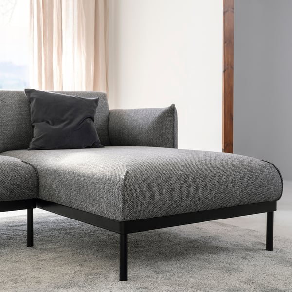 Modern grey fabric sofa with black metal legs and single cushion.