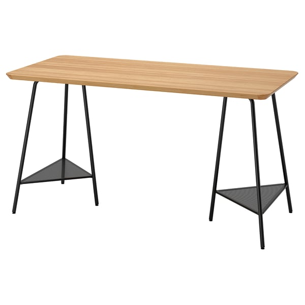 An ANFALLARE desk with a light bamboo top and black metal trestle legs, providing storage under the table.