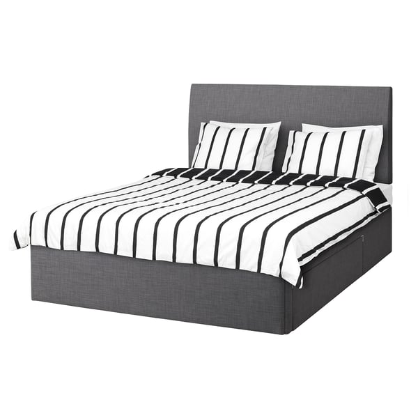 BALESTRAND bed in grey fabric, rectangular, with black and white striped bedding.