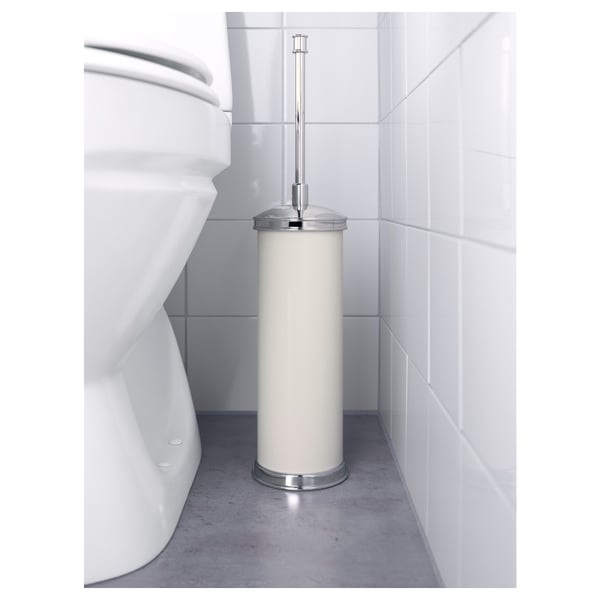 Cylindrical white brush holder with chrome handle beside white toilet, part of the BALUNGEN series, designed for replaceable brush head.
