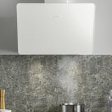White wall-mounted range hood with led lights above a marble backsplash, featuring multiple speeds and a touch control panel.