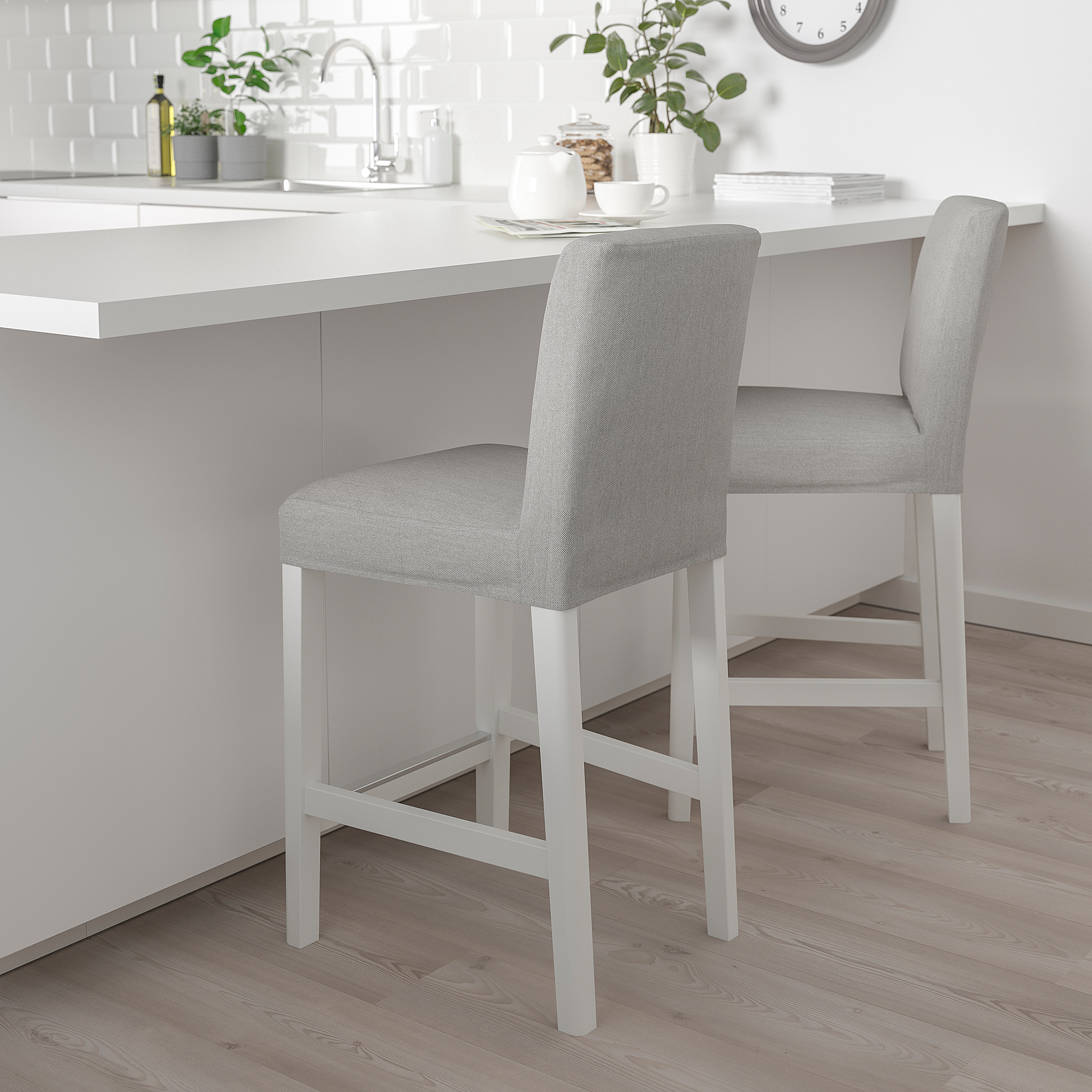 Two grey BERGMUND bar stools with cushions under kitchen island.
