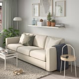 Living room with shelf, sofa, and decor.