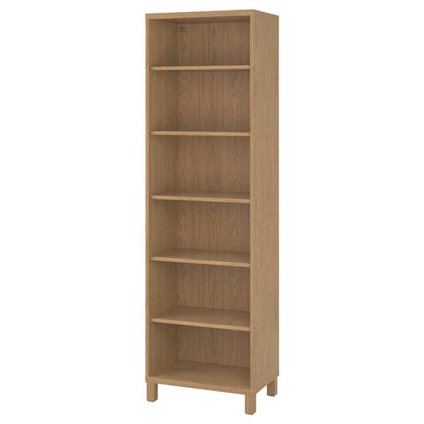 An upright BESTÅ light brown bookshelf with five shelves, crafted from wood.