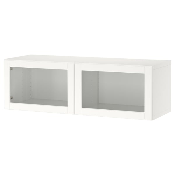 A white BESTÅ unit with two glass doors. Its rectangular, made of particleboard and glass, featuring a minimalist design.