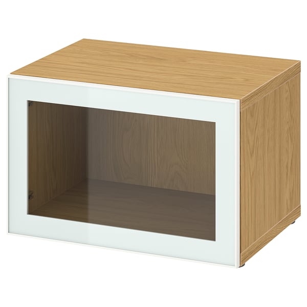 Light wood BESTÅ storage unit with glass doors.