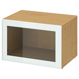 Light wood BESTÅ storage unit with glass doors.