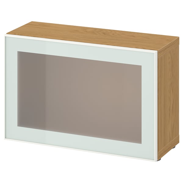 Modern BESTÅ storage unit: white frame, frosted glass door, light wood top & sides.