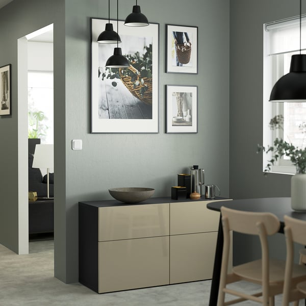 Modern room with BESTÅ sideboard, bowl, kettle, photos, lights, chair, large window.